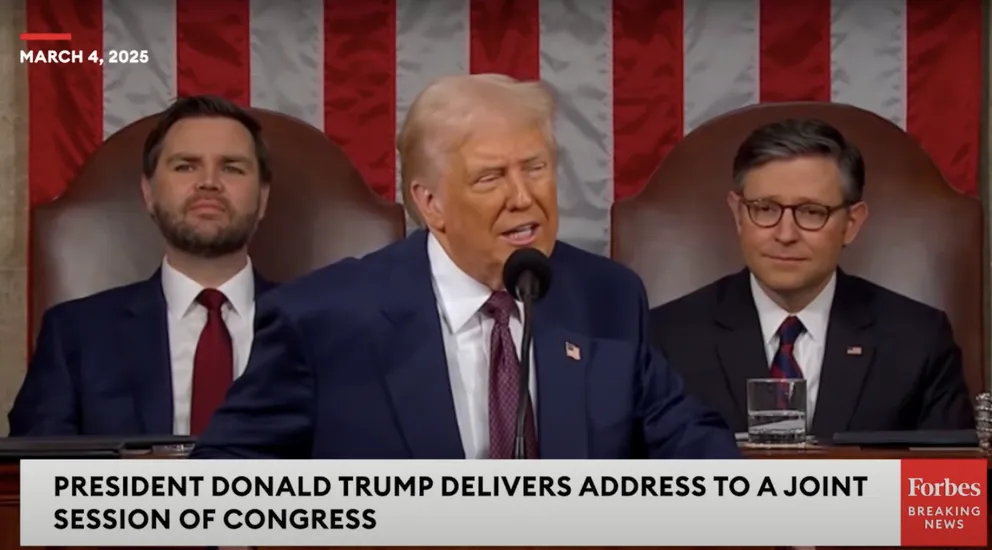 President Donald Trump acknowledging First Lady Melania Trump during his address to Congress with Vice President JD Vance and another political figure seated behind him, posted on March 5, 2025. | Source: YouTube/Forbes Breaking News